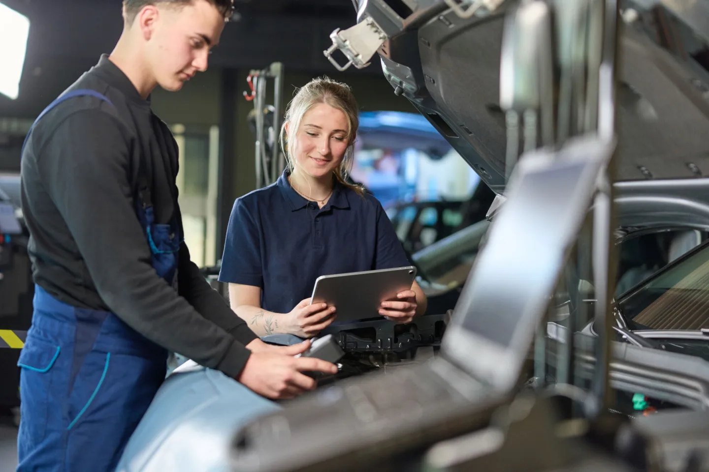 Studenten Autotechniek analyseren en lezen een elektrische auto