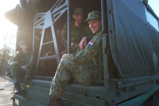 Groepsfoto VEVA-studenten Defensie zitten samen in legertruck